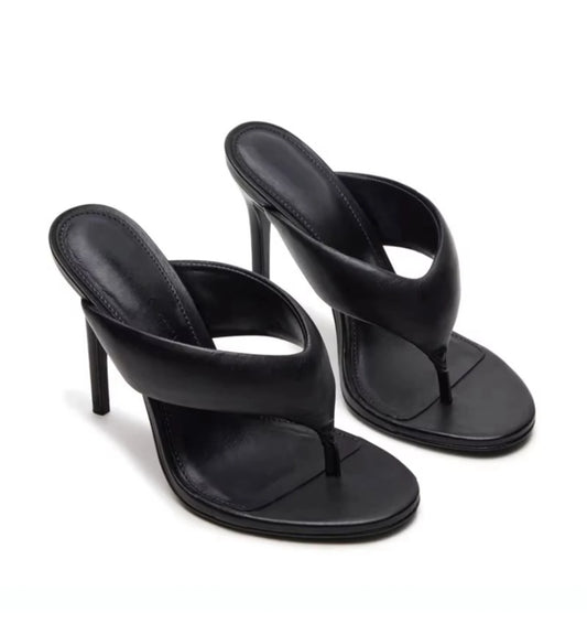 Black high-heeled sandals on a white background