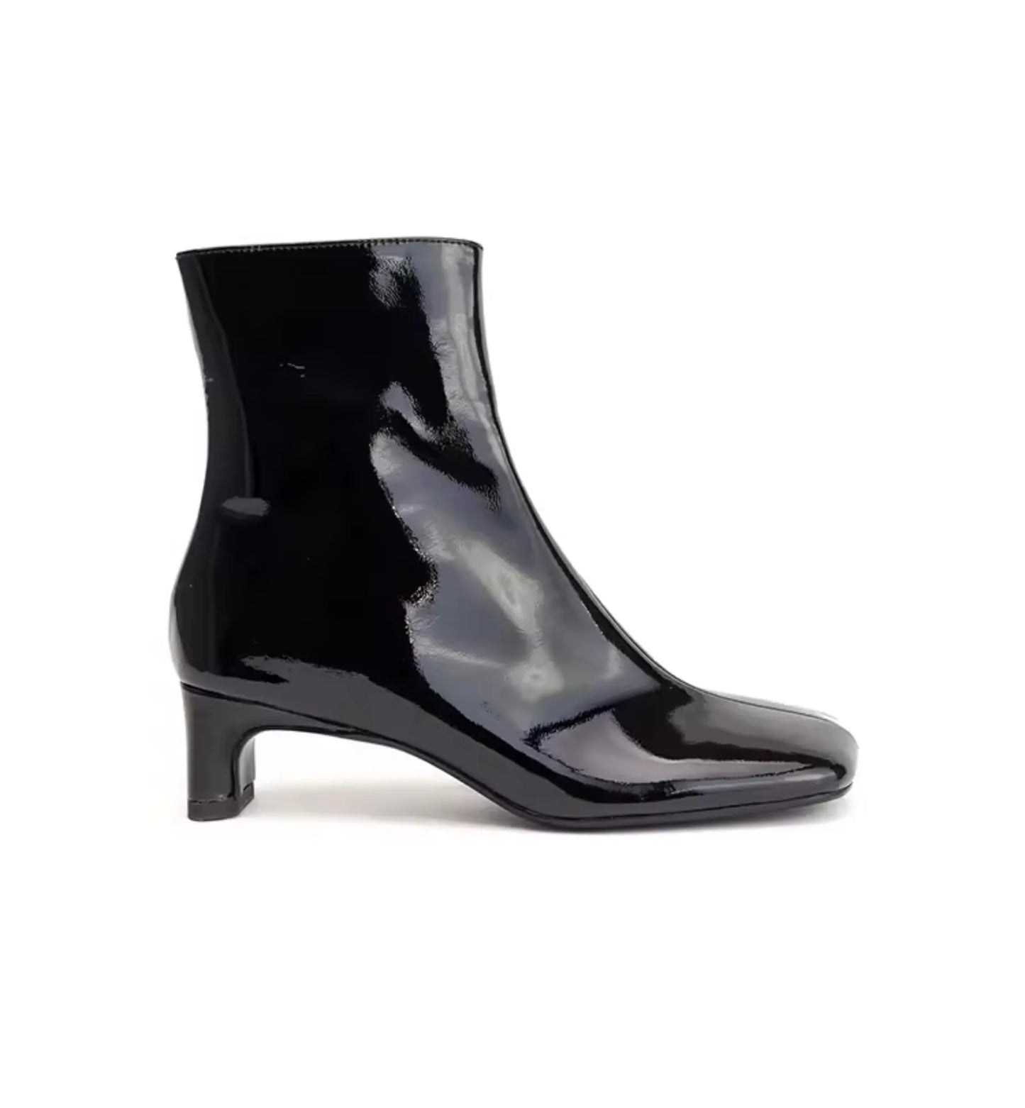 Black patent leather ankle boot on a white background