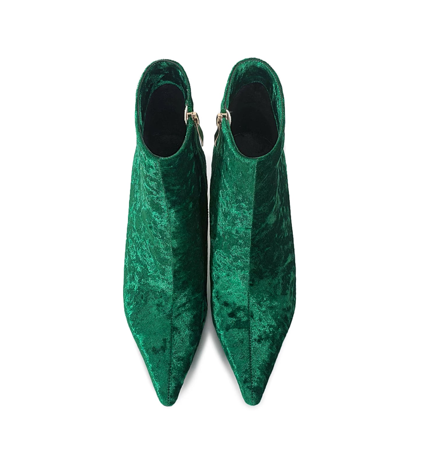 Pair of green velvet pointed-toe shoes on a white background