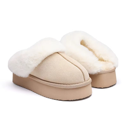 Pair of beige slippers with white fur lining on a white background