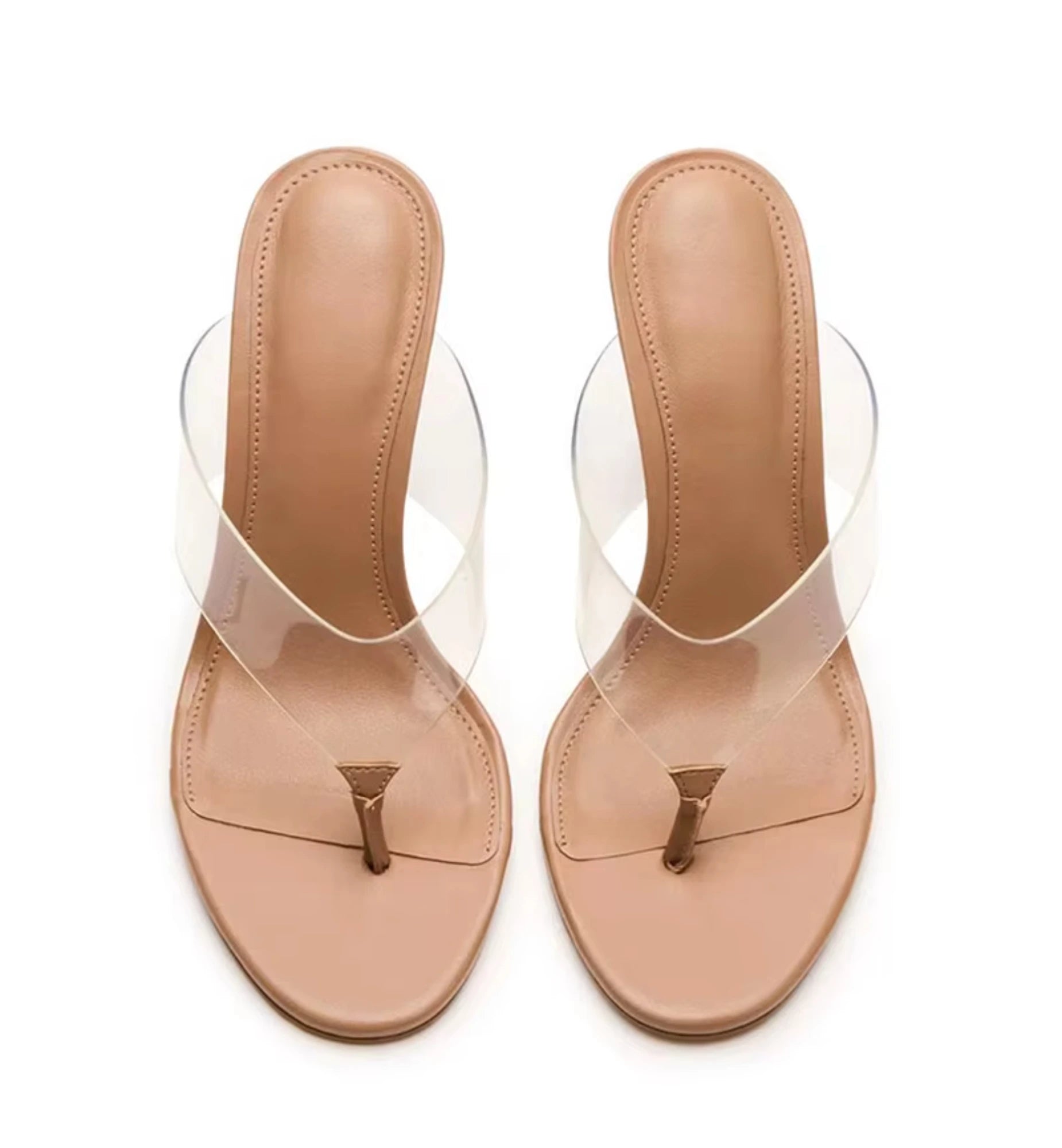 Pair of beige sandals with clear straps on a white background