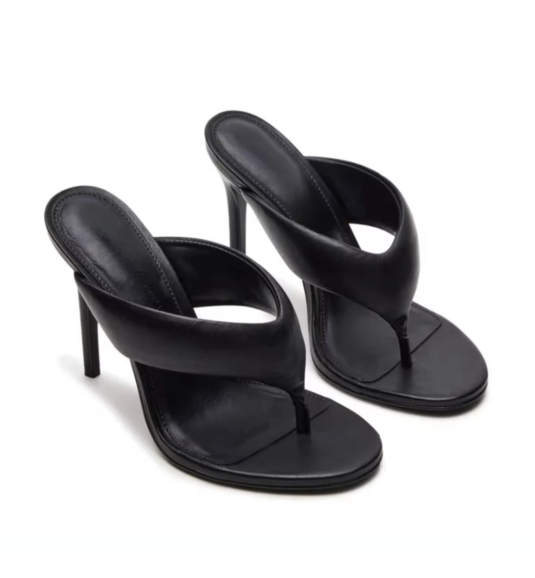 Black high-heeled sandals on a white background