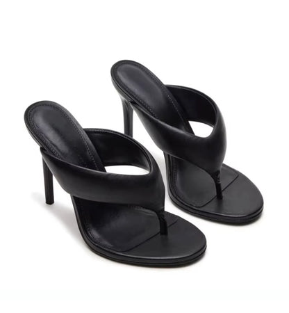 Black high-heeled sandals on a white background