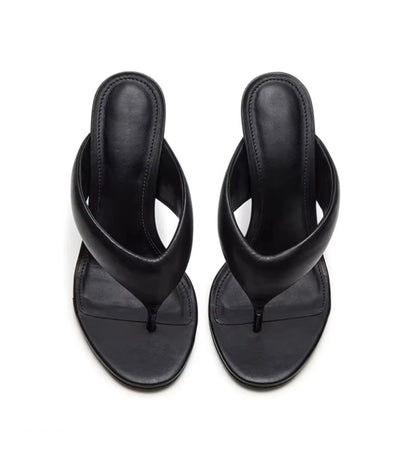 Pair of black sandals on a white background
