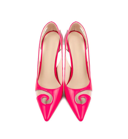 Pair of bright pink high-heeled shoes with decorative elements on a white background