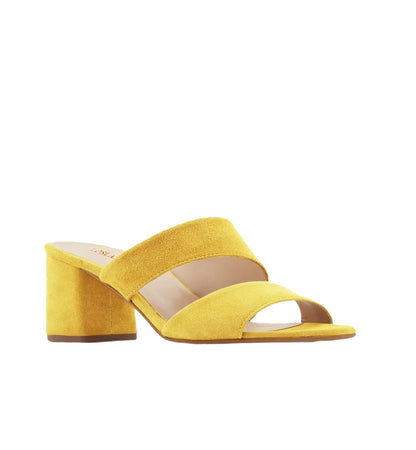 Yellow sandal with a block heel on a white background