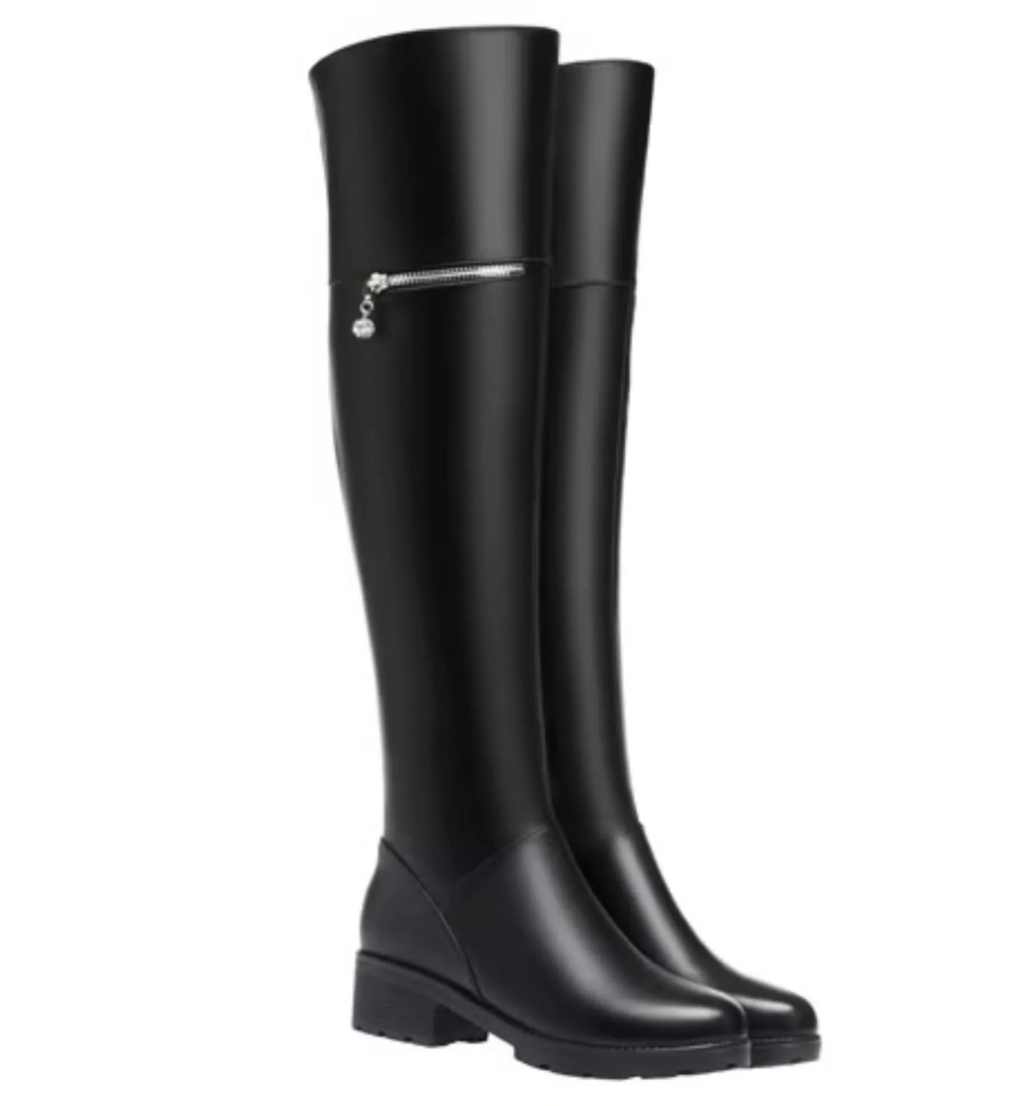 Black knee-high boots with a silver zipper on a white background
