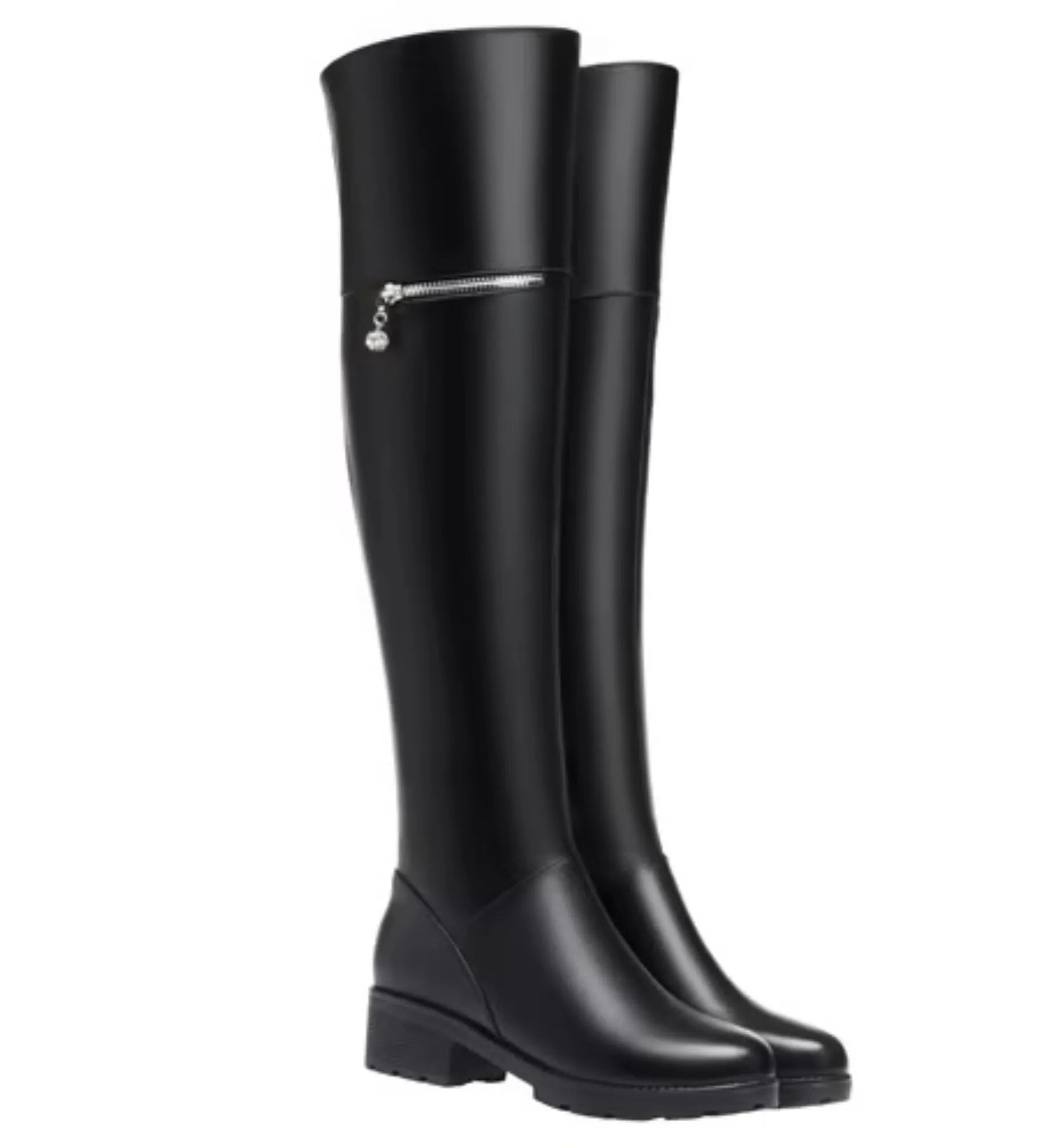 Black knee-high boots with a silver zipper on a white background