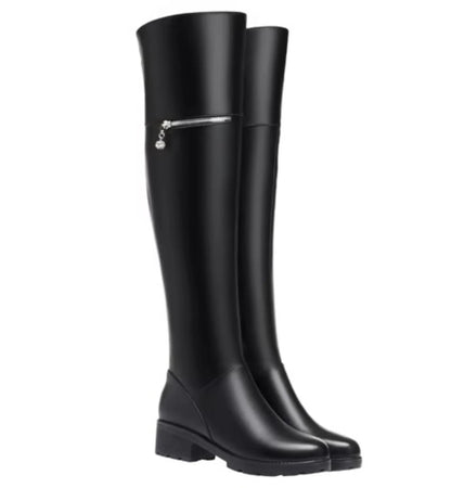 Black knee-high boots with a silver zipper on a white background
