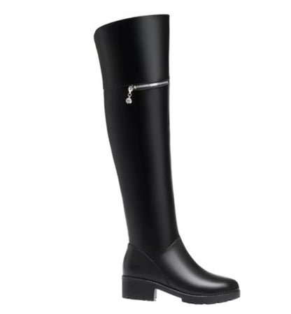 Black knee-high boot with a silver zipper on a white background