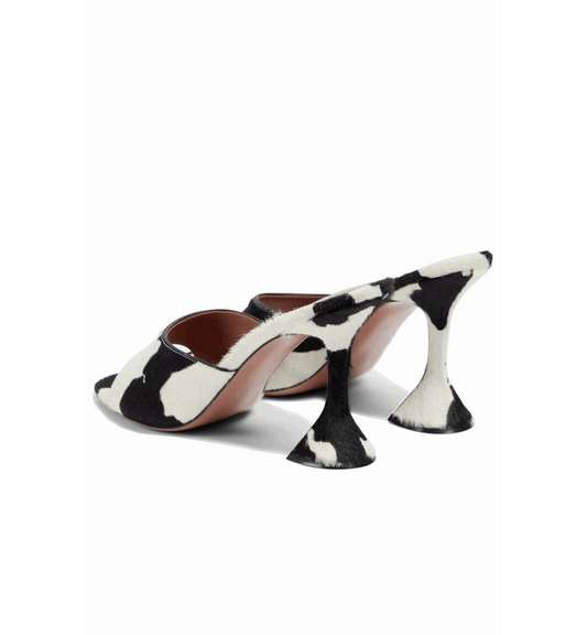 Black and white cow print high-heeled shoes on a white background