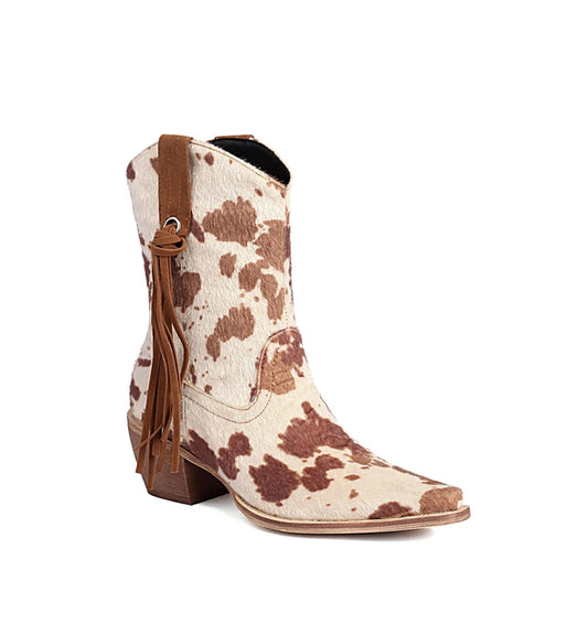 Cowboy boot with brown and white cowhide pattern on a white background
