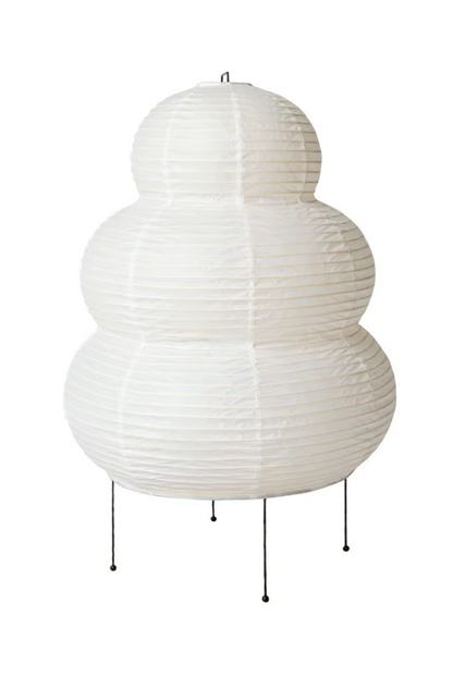 White rice paper floor lamp with sculptural rounded shape and thin metal stand.