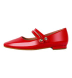 Red patent leather flat shoe with a strap on a white background