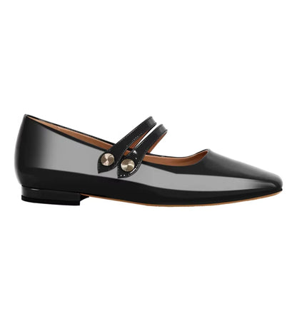 Black patent leather flat shoe with a strap on a white background