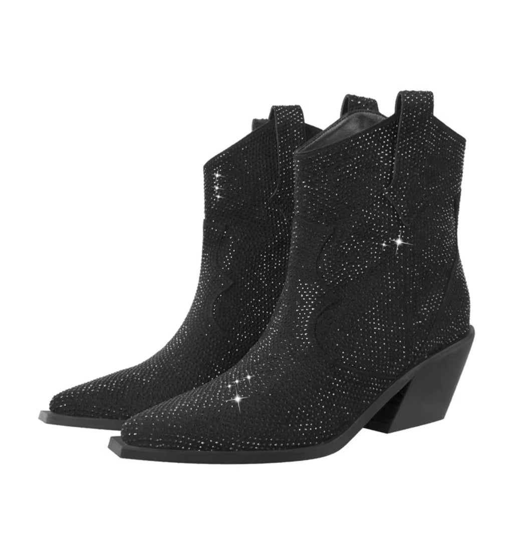 Black cowboy boots with rhinestone embellishments on a white background