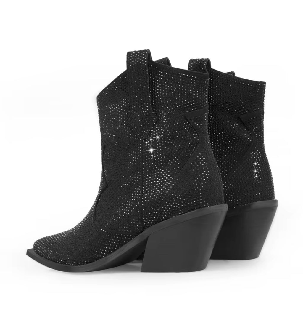 Black cowboy boots with rhinestone embellishments on a white background