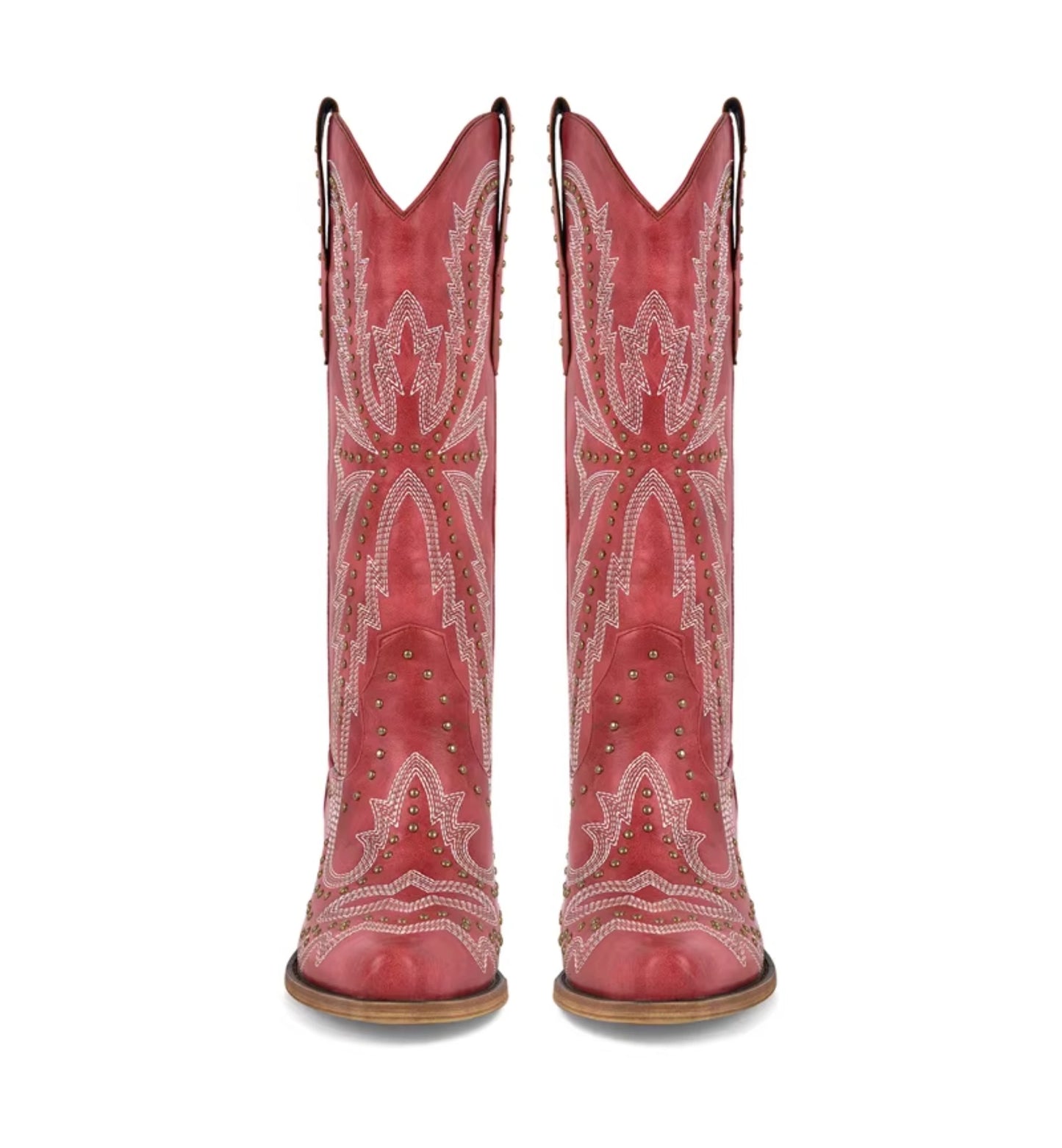 Red cowboy boots with white embroidery and studded details on a white background