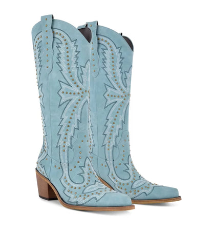 Light blue cowboy boots with intricate designs and brown soles on a white background