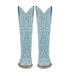 Light blue cowboy boots with studded details on a white background