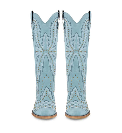 Light blue cowboy boots with studded details on a white background