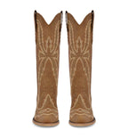 Pair of tan cowboy boots with decorative patterns on a white background
