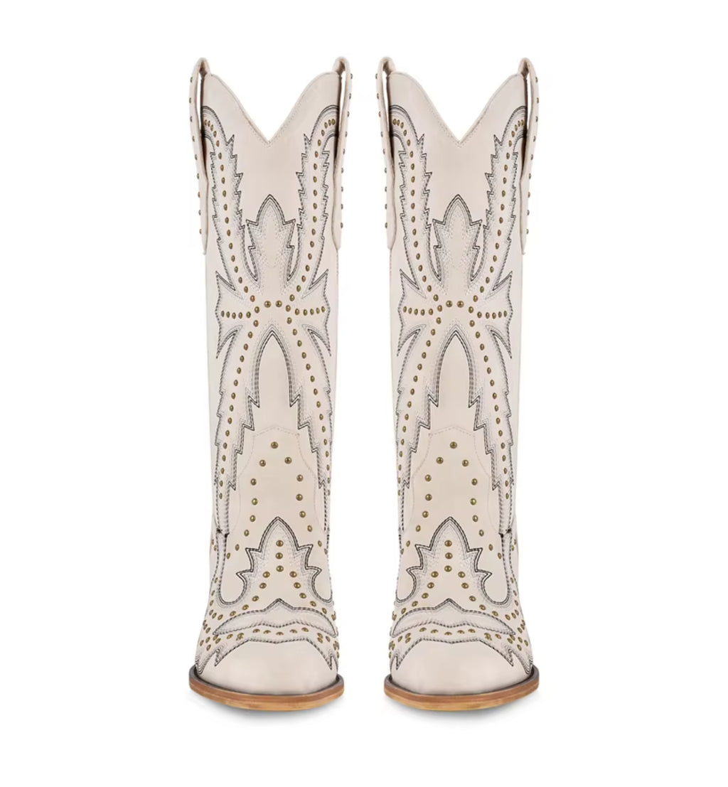 White cowboy boots with star designs and brown soles on a white background