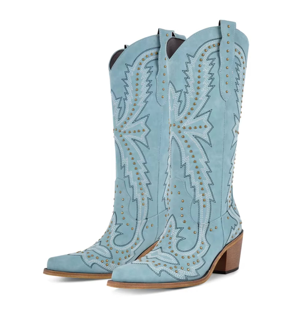 Light blue cowboy boots with intricate designs on a white background