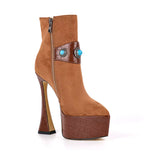 Brown high-heeled platform boot with decorative element on a white background