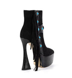 Black high-heeled platform boots with turquoise buttons and fringes on a white background