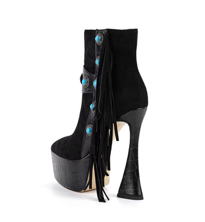 Black high-heeled boot with turquoise embellishments on a white background