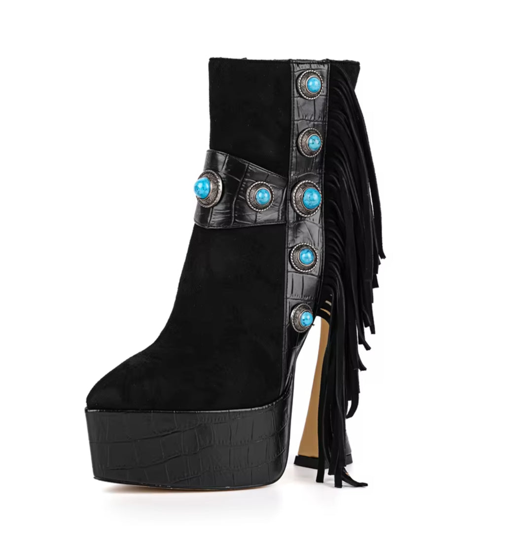Black platform boot with turquoise embellishments on a white background