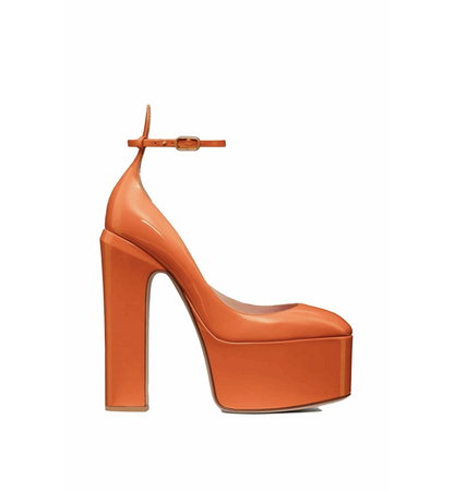 Orange high-heeled platform shoe on a white background