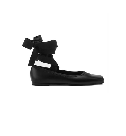 Black flat shoe with bow detail on a white background