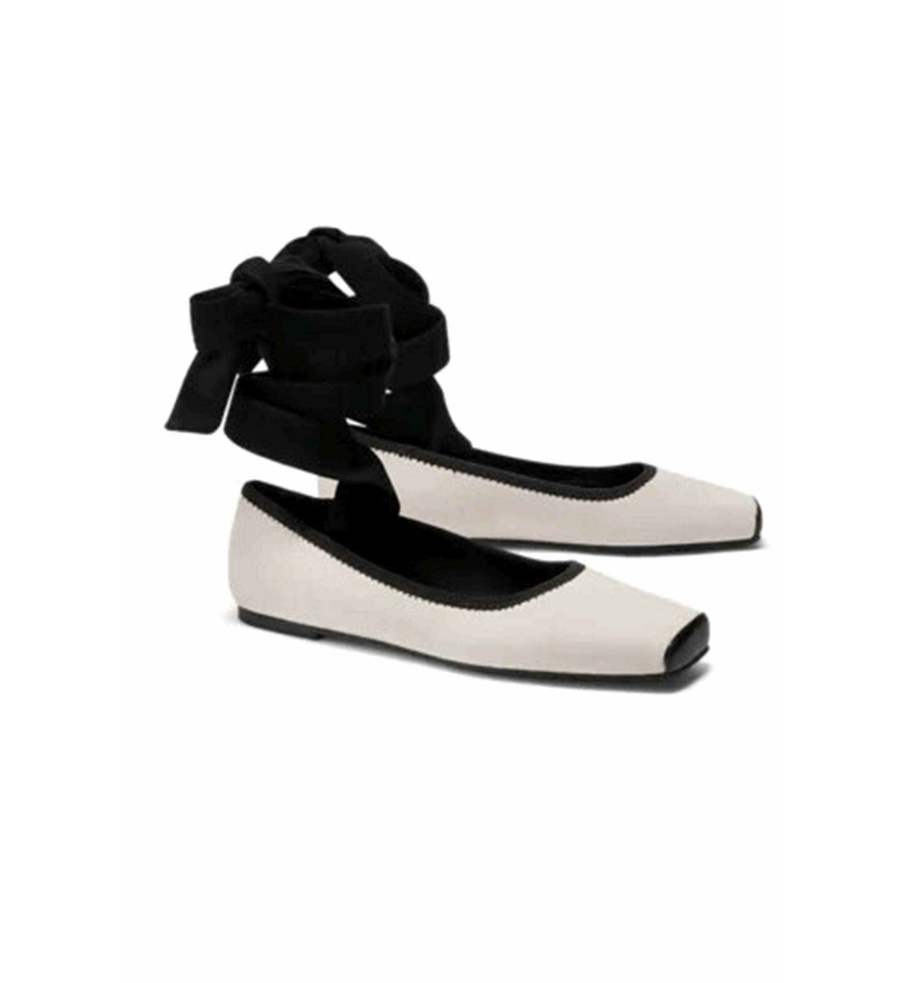 Pair of white shoes with black ribbons on a white background