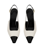 White high-heeled shoes with black toes and heels on a white background