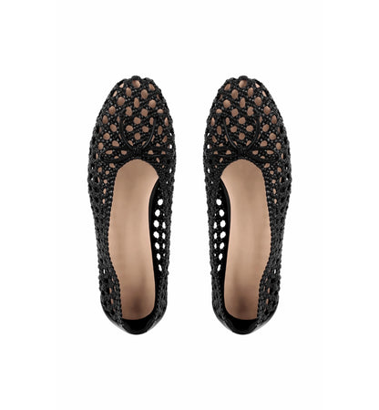 Pair of black crochet flat shoes on a white background