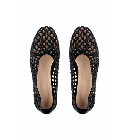 Black crochet flat shoes on a white background