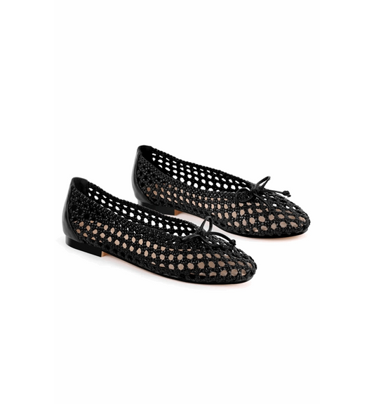 Black perforated ballerina shoes on a white background