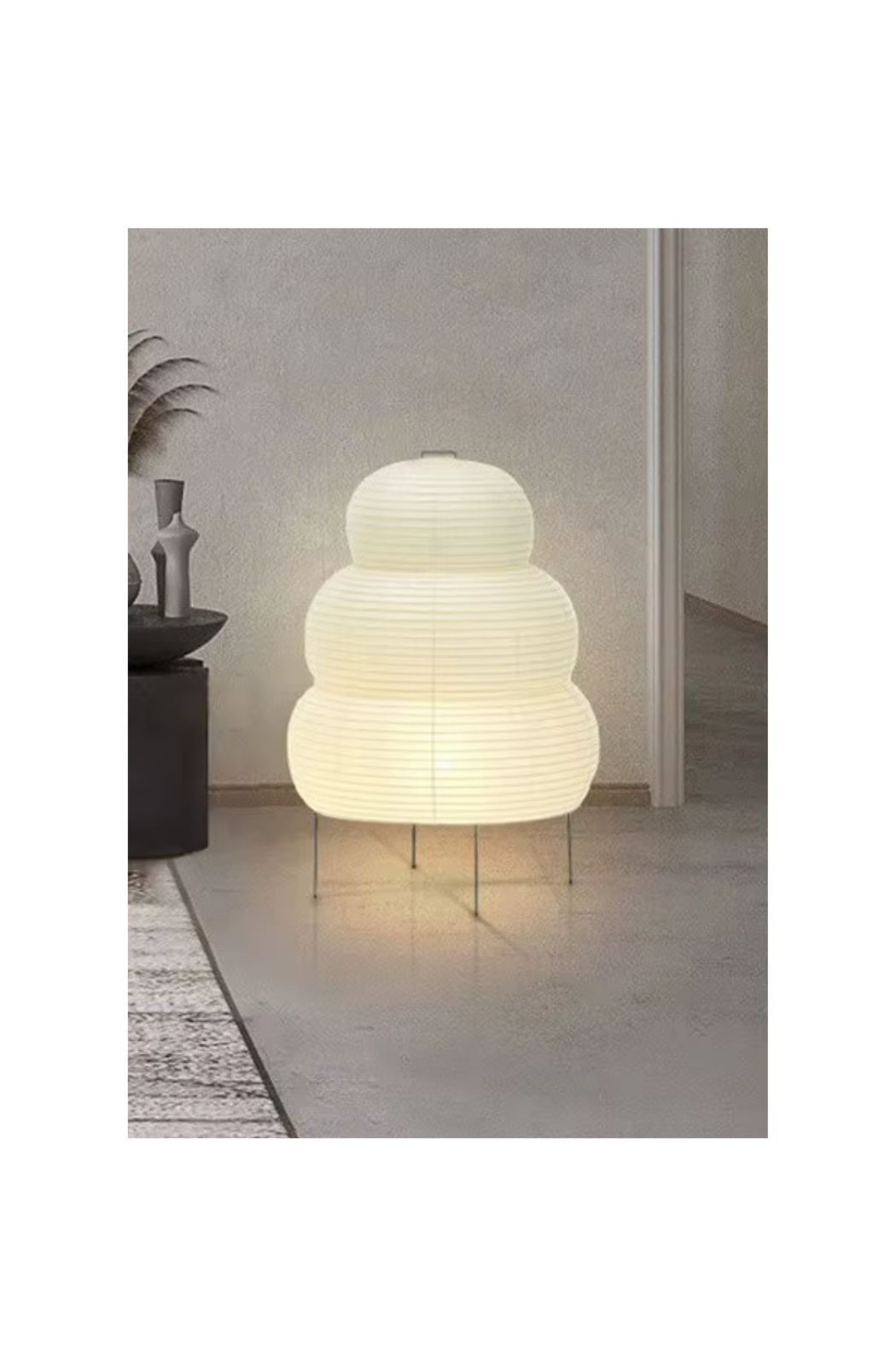 Lantern-inspired paper floor lamp emitting soft light, ideal for cozy minimalist spaces