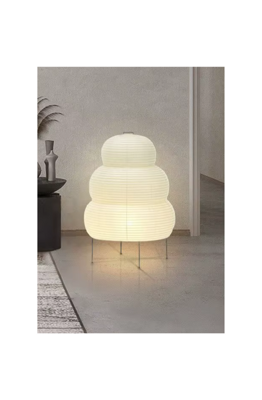Lantern-inspired paper floor lamp emitting soft light, ideal for cozy minimalist spaces
