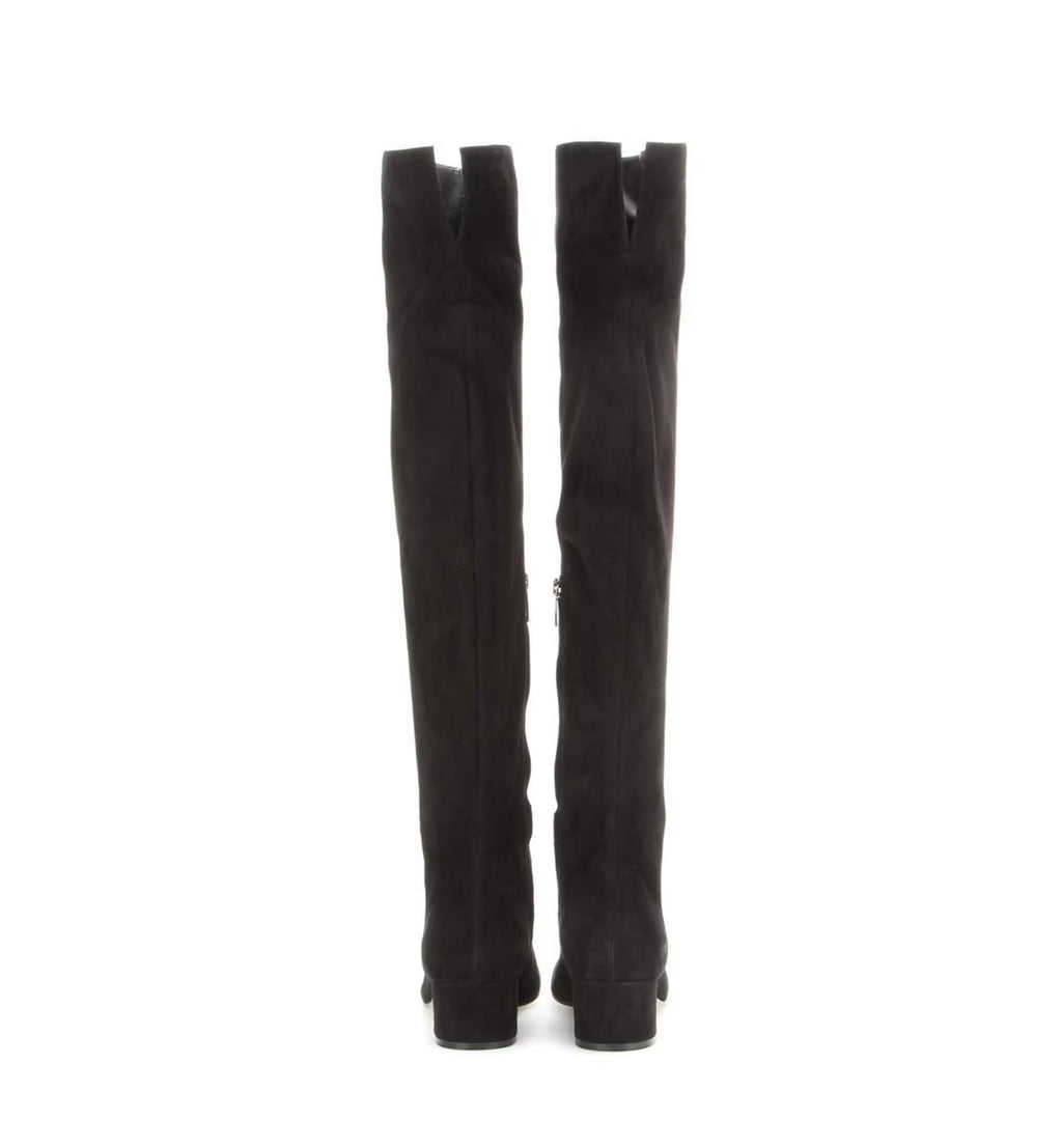 Black knee-high boots on a white background