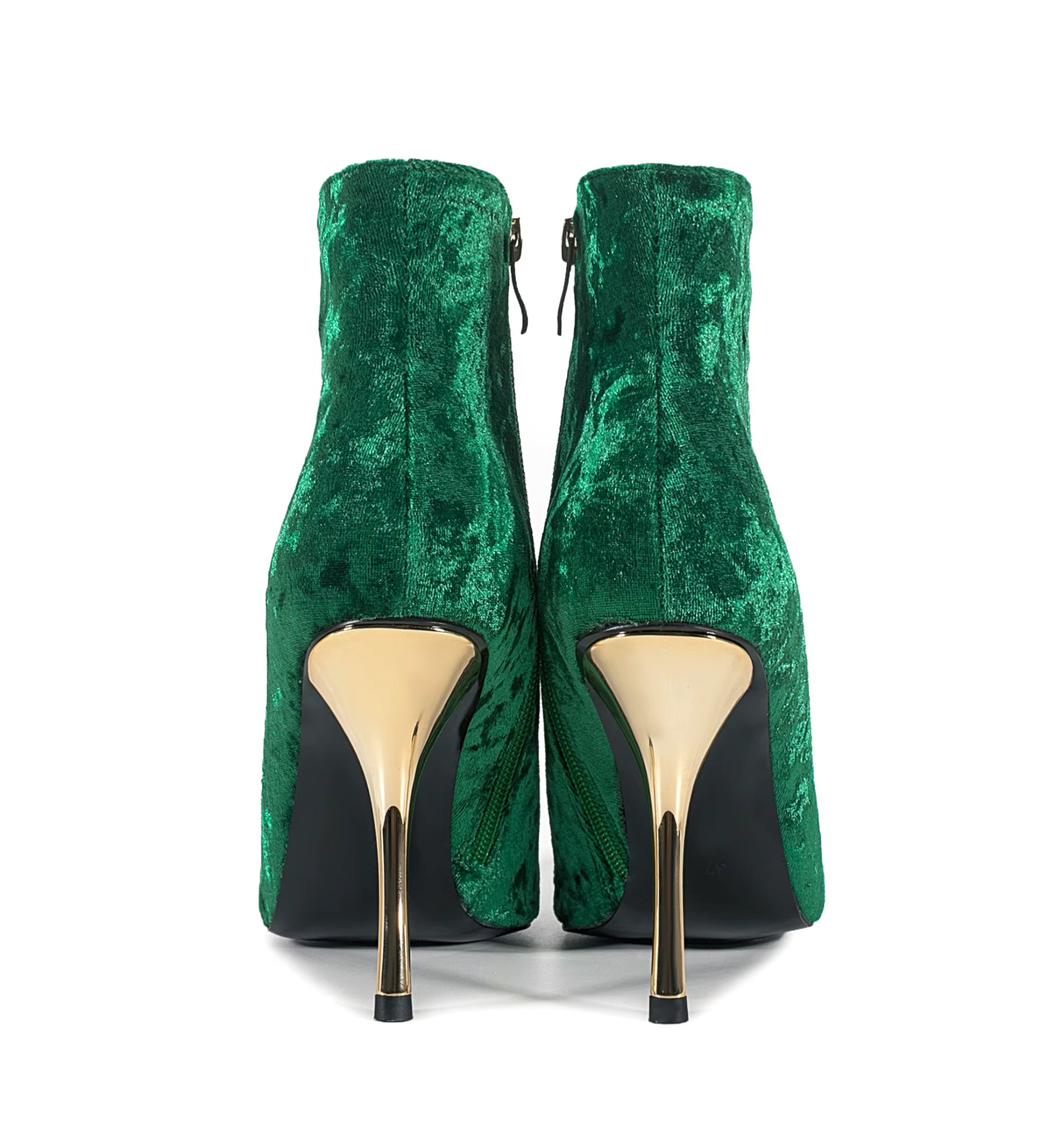 Green velvet high-heeled shoes with gold soles on a white background