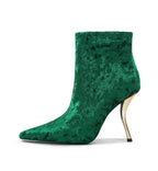 Green velvet high-heeled boot on a white background