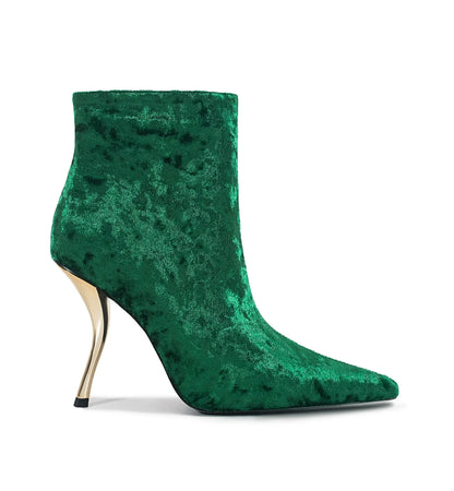 Green velvet ankle boot with a high heel on a white background