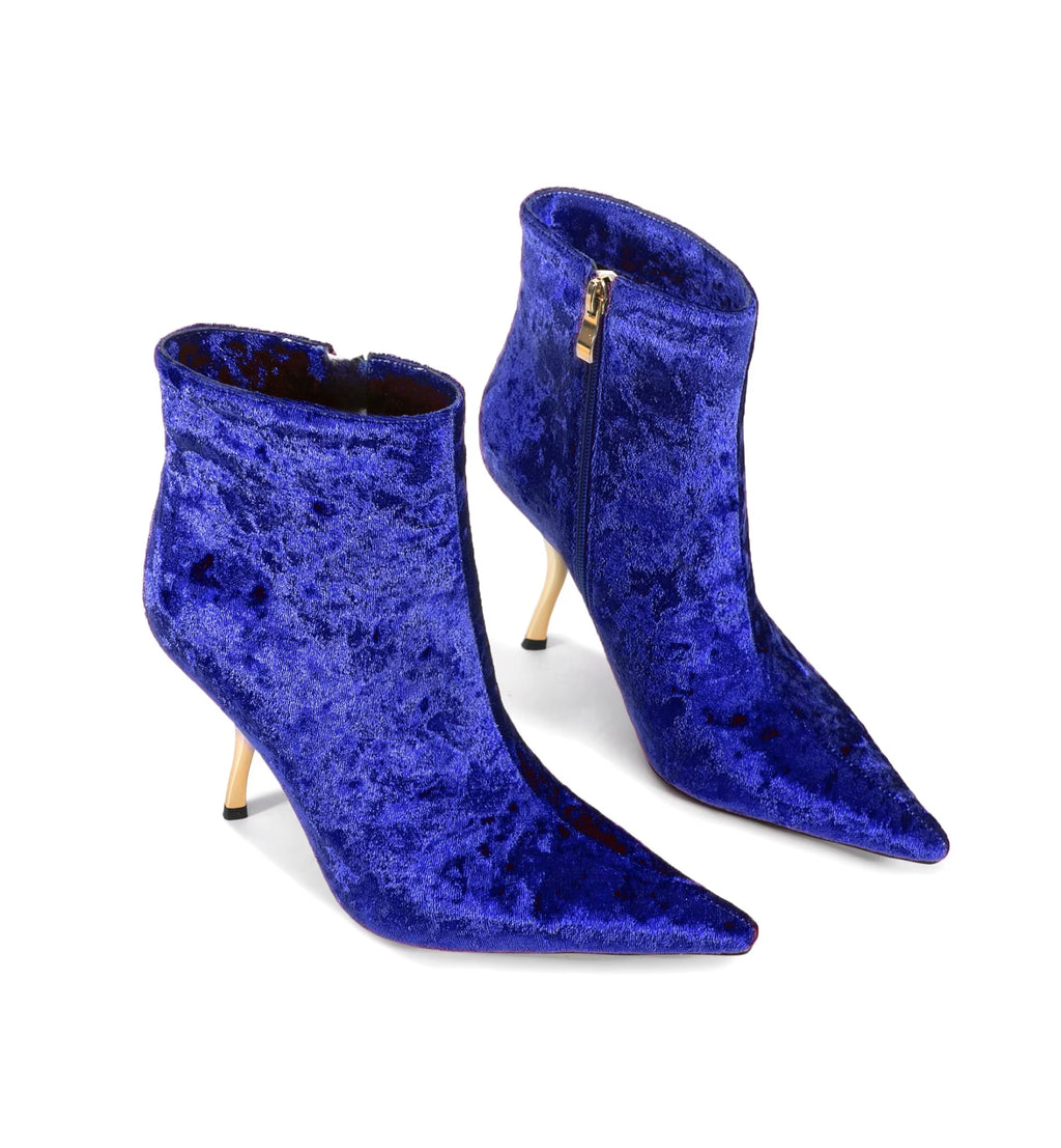 Pair of blue velvet high-heeled ankle boots on a white background