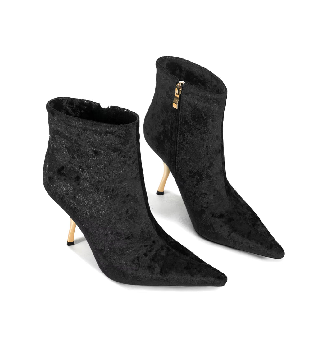 Black suede ankle boots with stiletto heels on a white background