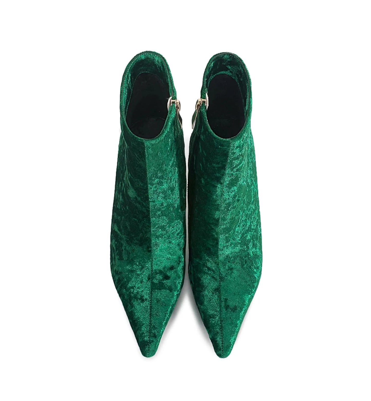 Pair of green velvet pointed-toe shoes on a white background