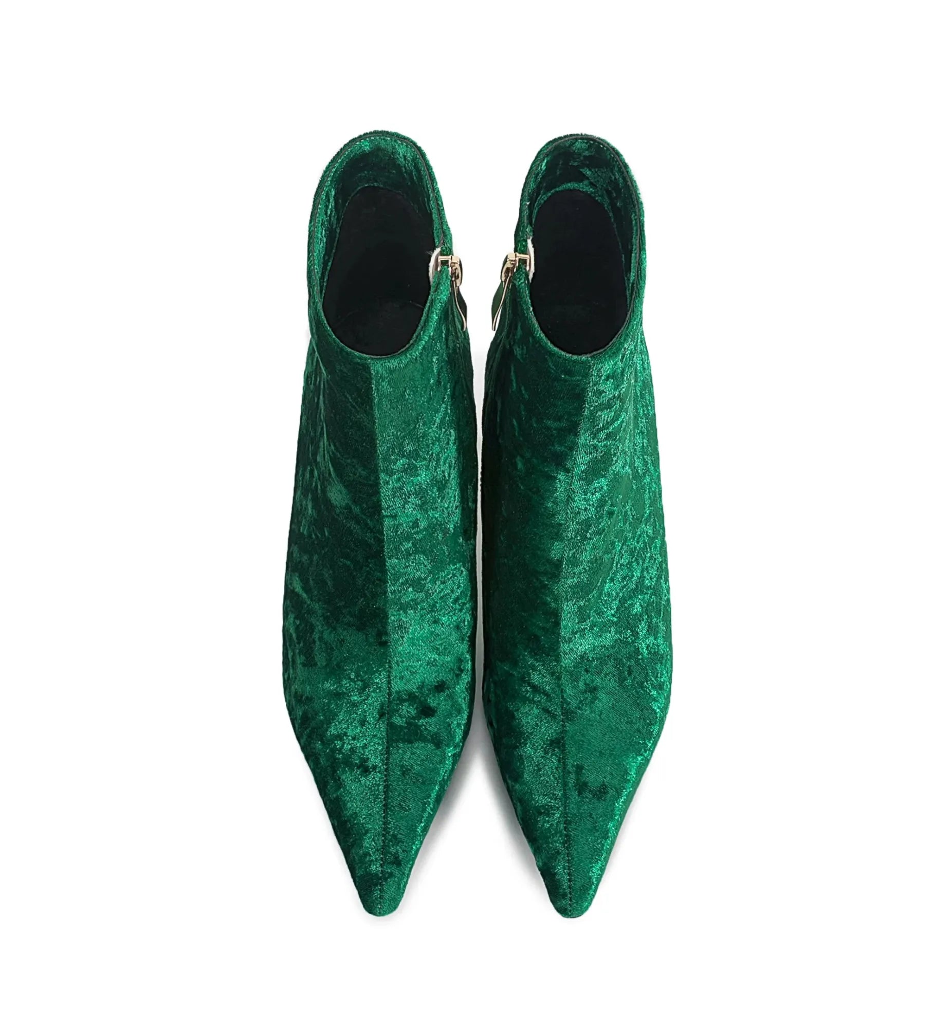 Pair of green velvet pointed-toe shoes on a white background