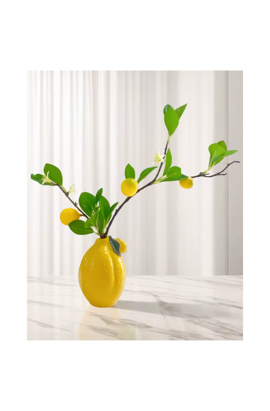Modern lemon-shaped decorative vase on a marble surface
